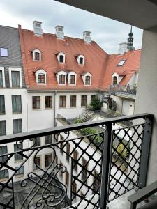 a view from the balcony of a building with red roofs at Exklusives Apartment mit einmaligem Blick zur Frauenkirche - Parkplatz kostenfrei in Dresden