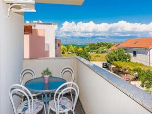 a balcony with a table and chairs and a view at New! Apartment Aenona 200m from the beach, Nin in Nin