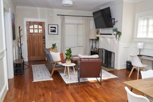 a living room with a table and a fireplace at Downtown Gem 5 Min To City, Near Marta & Pullman in Atlanta