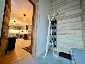 a room with a wooden wall and a white ladder at Leva des neiges in Lanslevillard