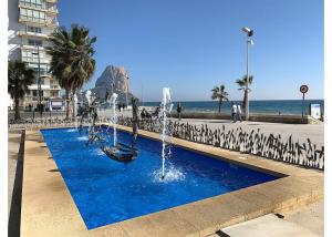 una fuente en una acera junto a la playa en Colón, en Calpe