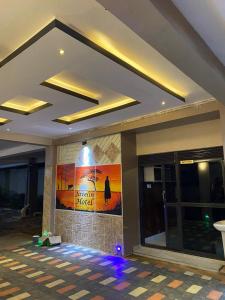 a lobby with a painting on the wall of a building at Javelin Hotel , Nansana, Kampala, Uganda in Kampala