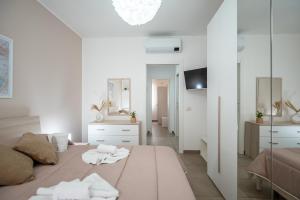 um quarto com uma cama grande e toalhas em KELIFOS Comfort Apartment em SantʼAgata di Militello