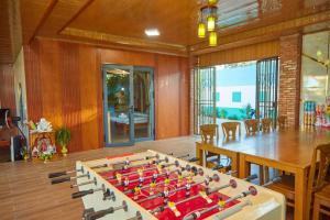 a large game table in a room with a table and chairs at Khoảnh Khăc Homestay in Vung Tau