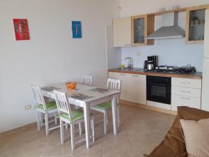 a kitchen with a table and chairs in a kitchen at Pandora Ocean View am Praia Cabral in Sal Rei