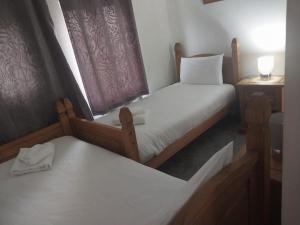 a small bedroom with two beds and a window at Old Town Retreat - Walking distance of most events in Ore