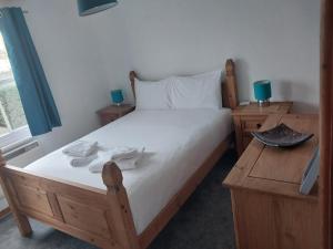 a bedroom with a wooden bed with two night stands at Old Town Retreat - Walking distance of most events in Ore