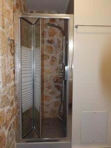 a shower with a glass door in a bathroom at Meganisi Villa Armonia - Private Pool Oasis in Vathí