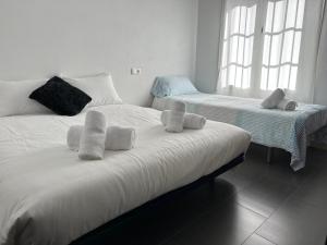 a bedroom with two beds with towels on them at CASA ROSAL in Cañada Rosal