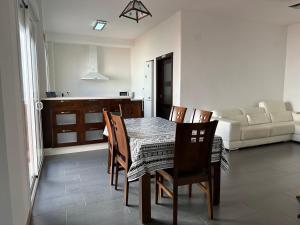 a kitchen and dining room with a table and chairs at CASA ROSAL in Cañada Rosal