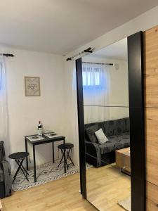a living room with a mirror and a table and a couch at Nanny in Novi Sad