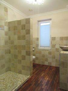 a bathroom with a shower and a sink and a window at Ferienwohnung Strand EG in Fehmarn +23 photos