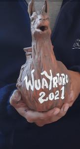 a person holding a vase with a dog on it at CABAÑAS LA LUCRECIA mono in Humahuaca