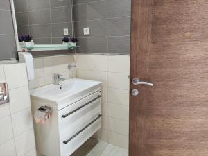 a bathroom with a sink and a mirror at Hillside Apartment with Sea View in Budva