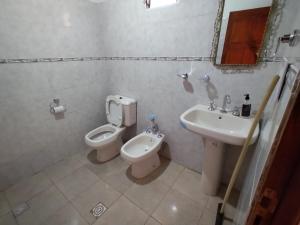 a bathroom with a toilet and a sink at CABAÑAS LA LUCRECIA mono in Humahuaca