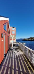 a wooden dock with a building and the water at Lofoten Rorbu - Odin bua in Stamsund