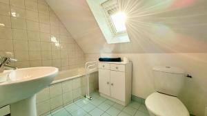 a bathroom with a toilet and a sink and a window at Pommeraie et Eglantines in Quend +85 photos