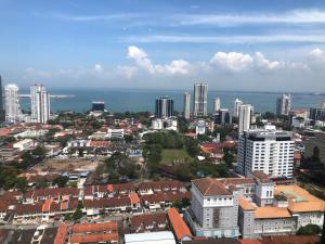an aerial view of a city with buildings and the ocean at Tropicana 218 Macalister Netflix Unit by Blue Sky Holidays in George Town