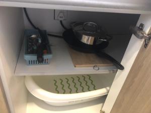 a kitchen cabinet with a pot on top of a toilet at Tropicana 218 Macalister Netflix Unit by Blue Sky Holidays in George Town