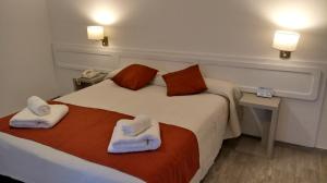 Una habitación de hotel con una cama con toallas. en Gran Hotel Fontainebleau en San Clemente del Tuyú