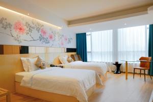 Voodi või voodid majutusasutuse Paco Hotel Beijing Road Tuan Yi Da Metro Guangzhou toas