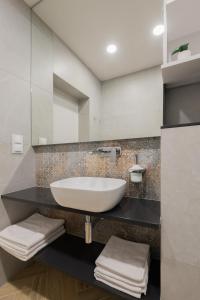 a bathroom with a white sink and a mirror at AVAPARTS Apartament FAMILY in Jastarnia