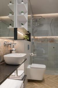 a bathroom with a sink and a toilet and a shower at AVAPARTS Apartament FAMILY in Jastarnia