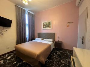 una camera d'albergo con letto e finestra di Locanda San Lorenzo a Firenze