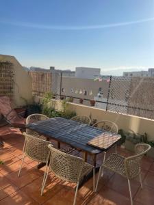 stół i krzesła na patio z balkonem w obiekcie Appart 60 m2 avec terrasse 35m2 séjour sud et 2 vraies chambres gare Saint-Charles w Marsylii