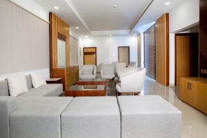 a waiting room with white couches and chairs at Elite Villa in Duqm