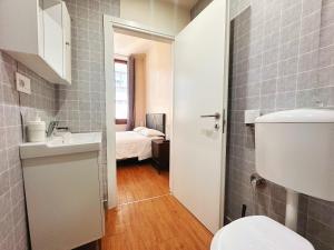 a bathroom with a sink and a toilet and a bedroom at Locanda San Lorenzo in Florence
