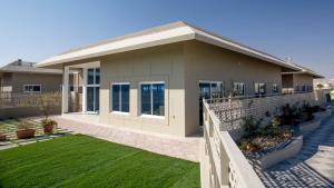 a house with a fence in front of it at Elite Villa in Duqm