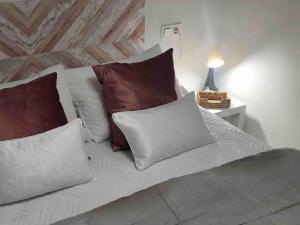 a white bed with pillows and a table with a lamp at Apartamento Andaluz CARMA in Torrox Costa +53 photos