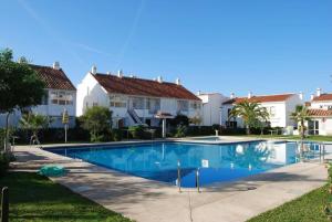 a swimming pool in front of some houses at Apartamento Andaluz CARMA in Torrox Costa
