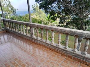 a balcony of a house with a brick floor at Sonidos de la Naturaleza!! in Los Altos de Cerro Azul