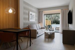 a living room with a couch and a table at Prinsotel La Dorada & Spa in Playa de Muro