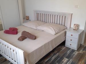 a white bed with two towels and a night stand at Pandora Ocean View am Praia Cabral in Sal Rei