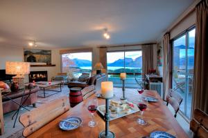 a living room with a table with wine glasses at Breath-taking Views Panorama Terrace in Queenstown