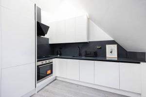 a white kitchen with white cabinets and a sink at 1Bedroom Flat Central London NW3 in London