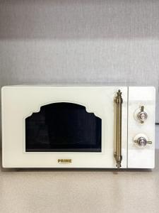 a white toaster oven sitting on a wall at Софія in Yasinya