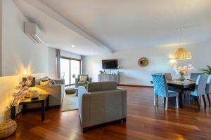 a living room with a couch and a table at Baia da Luz - Tropicana Beach Apartment in Luz