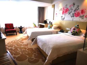 a hotel room with two beds and a chair at Paco Hotel Tuanyida Metro Guangzhou -Free ShuttleBus for Canton Fair in Guangzhou