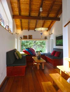a living room with a couch and a table at La Maison entre Deux Rivières The River Mountain House - Nohèdes in Nohèdes
