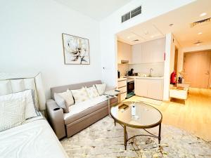 a living room with a couch and a table at Canal Front Haven 206WB12 in Abu Dhabi