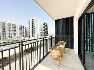 a balcony with a table and chairs and buildings at Canal Front Haven 206WB12 in Abu Dhabi