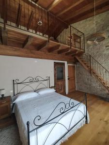 a bedroom with a large bed and a staircase at La Casa di LILLIA in Castelnovo neʼ Monti