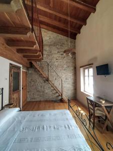 a bedroom with a large bed and a staircase at La Casa di LILLIA in Castelnovo neʼ Monti