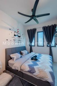 a bedroom with a bed with a ceiling fan at Comfy Studio Room by Moowin in Perai