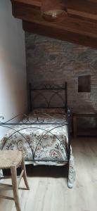 a bedroom with a bed and a wooden wall at La Casa di LILLIA in Castelnovo neʼ Monti