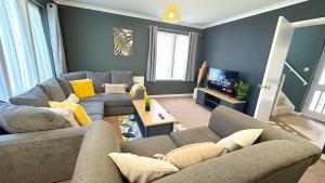 a living room with two couches and a tv at Huge Family House - Free Parking - Central Harrogate in Harrogate